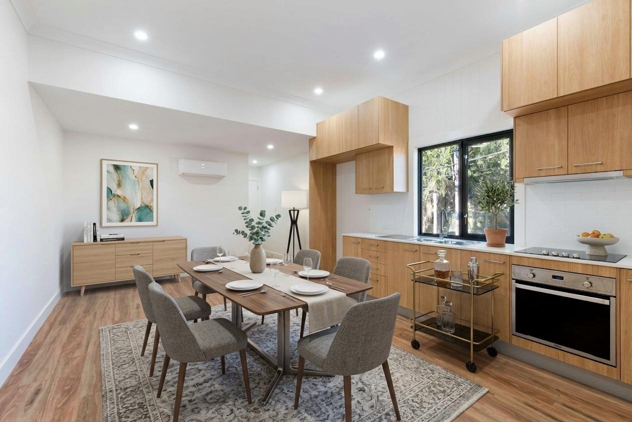 The same kitchen diner staged with a dining table for six and a sideboard
